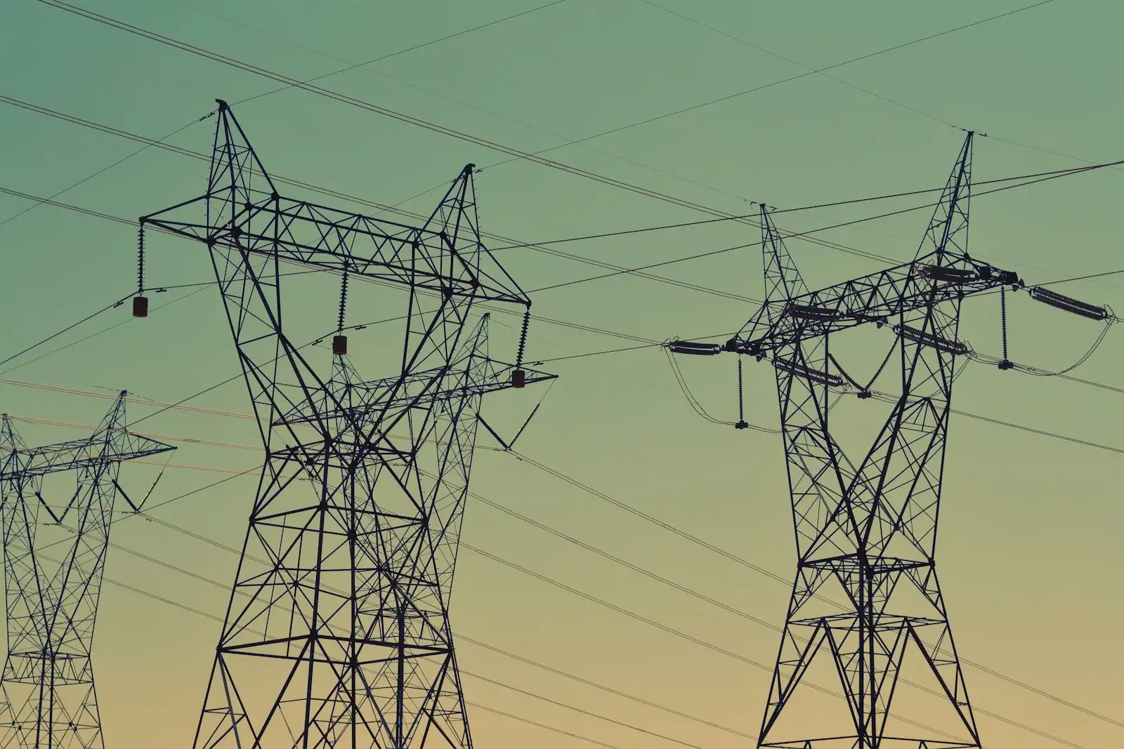 High-voltage electrical towers at sunset